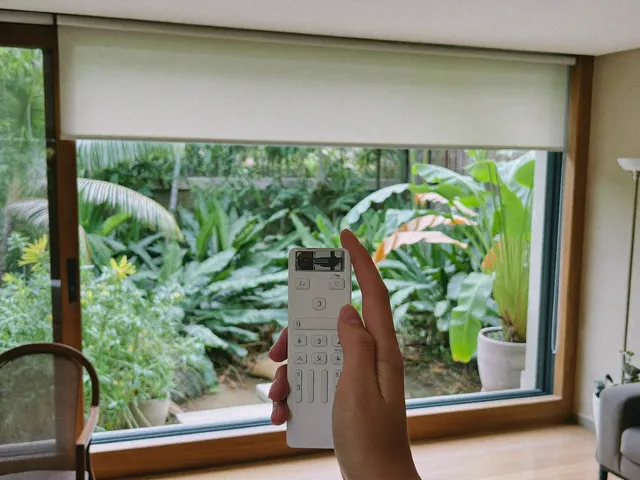 Remote control operating a motorized roller blind